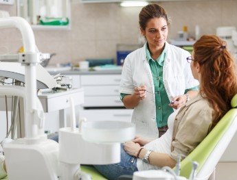 patient speaking with team member in dental chair in Morgan Hill